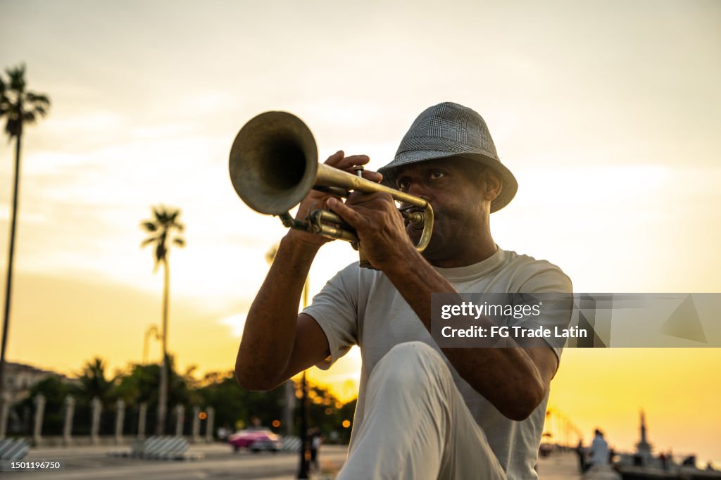 Mature man playing the trumpet on the streets of Havana, Cuba