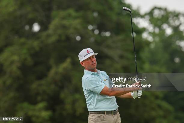 Chez Reavie of the United States watches his shot from the fifth tee during the third round of the Travelers Championship at TPC River Highlands on...