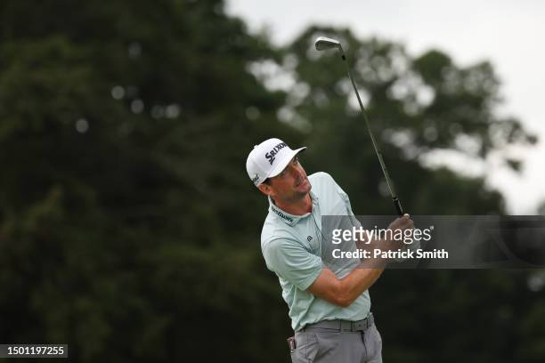 Keegan Bradley of the United States watches his shot from the fifth tee during the third round of the Travelers Championship at TPC River Highlands...