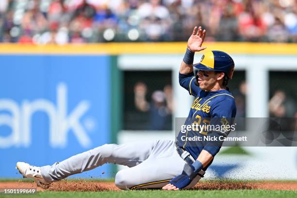 Christian Yelich of the Milwaukee Brewers advances to second base on a wild pitch during the first inning against the Cleveland Guardians at...