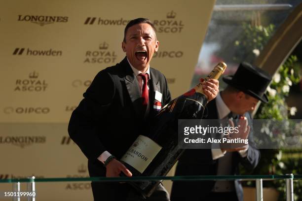 Jockey Frankie Dettori laughs as he is presented a big bottle of champagne after riding his final Race at Royal Ascot during day five of Royal Ascot...