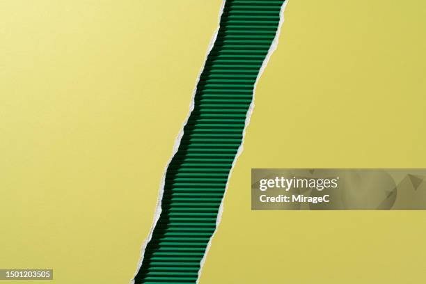 green paper torn in half on green corrugated paper - half open stock pictures, royalty-free photos & images