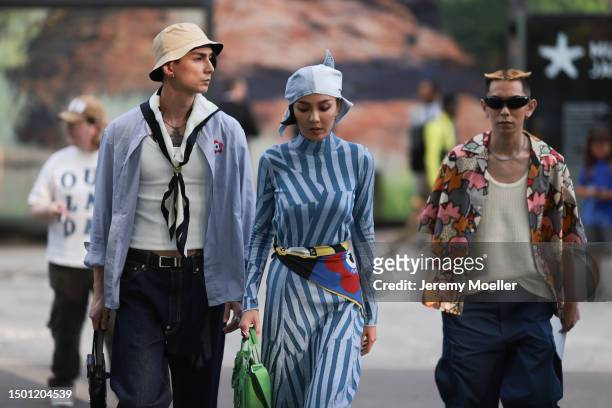Jun Chiu, Kiwi Lee and a friend outside the Kenzo show during the Menswear Spring/Summer 2024 as part of Paris Fashion Week on June 23, 2023 in...