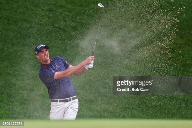 Chesson Hadley of the United States plays a shot from a bunker on the 15th hole during the third round of the Travelers Championship at TPC River...