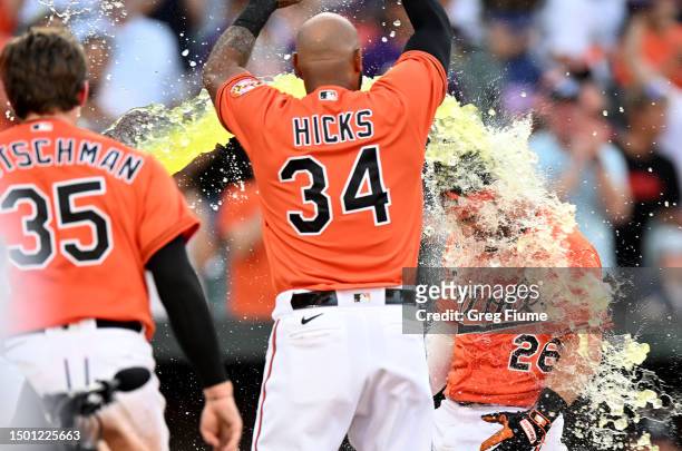Ryan McKenna of the Baltimore Orioles gets doused with Gatorade after hitting the game-winning two-run home run in the tenth inning against the...