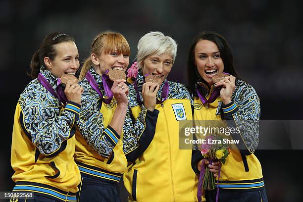 Bronze medalists Olesya Povh, Hrystyna Stuym, Mariya Ryemyen and Elyzaveta Bryzgina of Ukraine pose on the podium during the medal ceremony for the...