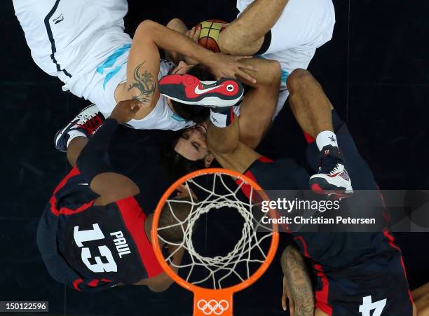 Carlos Delfino and Luis Scola of Argentina battle for the ball under the basket with Chris Paul and Tyson Chandler of United States in the third...