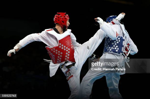 Nesar Ahmad Bahawi of Afghanistan competes against Mauro Sarmiento of Italy in the Men's -80kg Taekwondo Bronze Medal Finals bout on Day 14 of the...