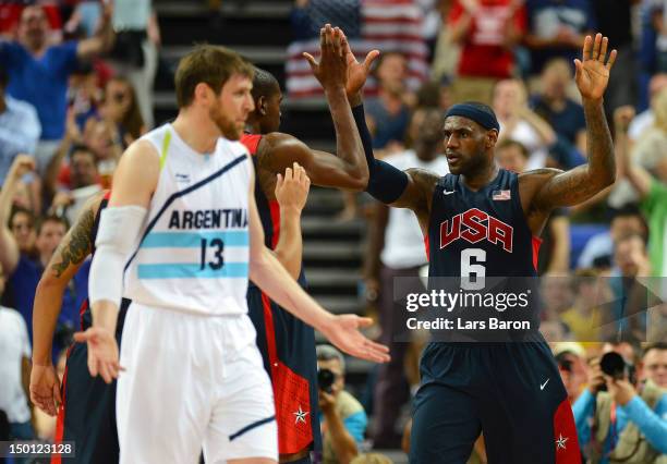 LeBron James of United States celebrates a play with Kevin Durant as Andres Nocioni of Argentina reacts in the second half during the Men's...