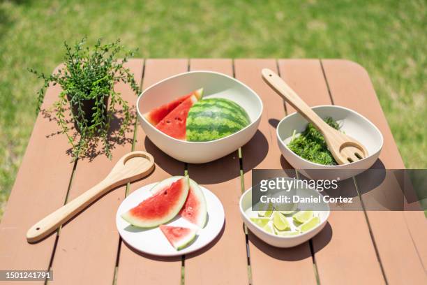a wooden tabletop is filled with a variety of dishes and bowls of food, colorful and inviting presentation - macrobiotic diet stock pictures, royalty-free photos & images