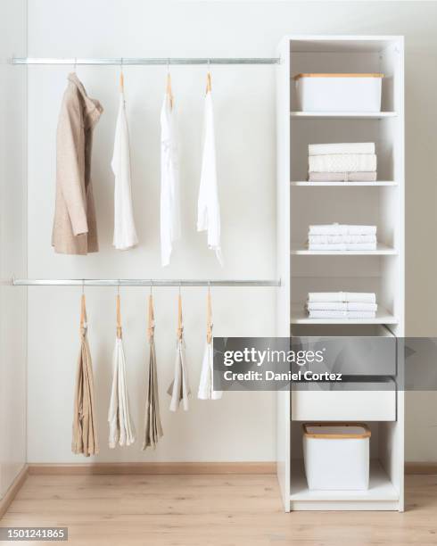 modern closet with multiple clothes, featuring drawers, open shelves and towel racks - suit rack stock pictures, royalty-free photos & images