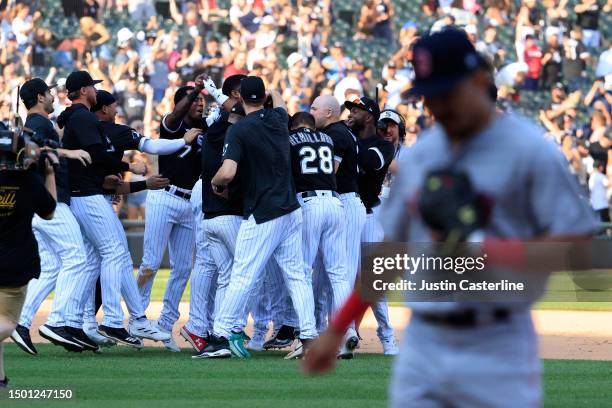 Elvis Andrus of the Chicago White Sox celebrates with his team after a walk off single in the ninth inning in the game in the game against the Boston...