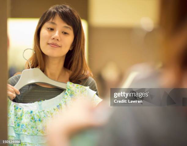 young woman trying on dress - fitting room stock pictures, royalty-free photos & images