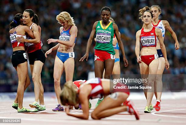 Morgan Uceny of the United States reacts after falling as Asli Cakir Alptekin of Turkey celebrates winning gold behind her during the Women's 1500m...