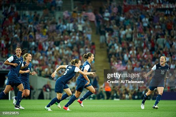 Summer Olympics: USA Carli Lloyd victorious with Kelley O'Hara and Rachel Buehler after scoring goal vs Japan during Women's Gold Medal Match at...