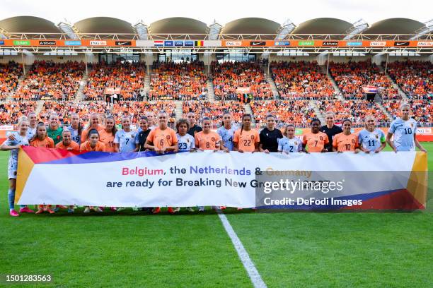 Players of the Netherlands and Belgium , a banner prior to the International Women´s Friendly match between Netherlands and Belgium at Parkstad...