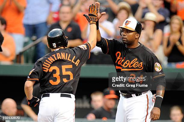 Omar Quintanilla of the Baltimore Orioles celebrates with Wilson Betemit after hitting a home run in the second inning against the Kansas City Royals...