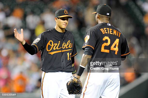 Manny Machado of the Baltimore Orioles celebrates with Wilson Betemit after a 7-1 victory against the Kansas City Royals at Oriole Park at Camden...