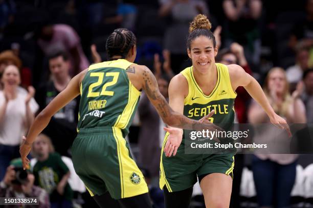 Yvonne Turner and Kia Nurse of the Seattle Storm react after a basket against the Phoenix Mercury during the fourth quarter at Climate Pledge Arena...