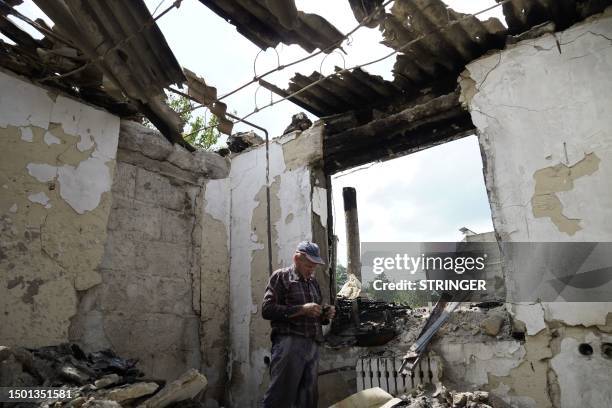 Local resident Mikhail is seen inside his house destroyed by Ukrainian strikes in the village of Novaya Tavolzhanka, near the border with Ukraine in...