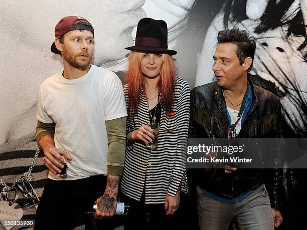 Photographer Kenneth Cappello, musicians Alison Mosshart and Jamie Hince of The Kills pose before signing their book "Dream and Drive" at Bookmarc on...
