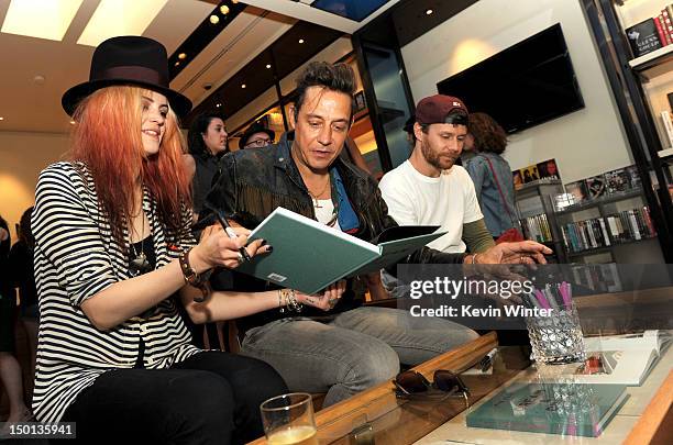 Musicians Alison Mosshart, Jamie Hince of The Kills and photographer Kenneth Cappello sign their book "Dream and Drive" at Bookmarc on August 10,...