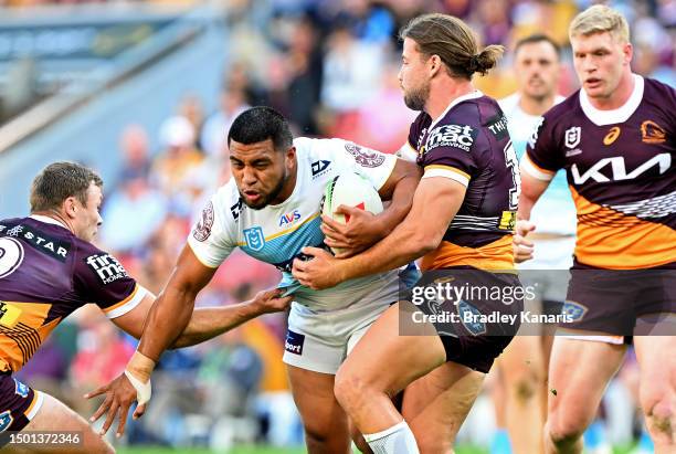 Moeaki Fotuaika of the Titans takes on the defence during the round 17 NRL match between Brisbane Broncos and Gold Coast Titans at Suncorp Stadium on...