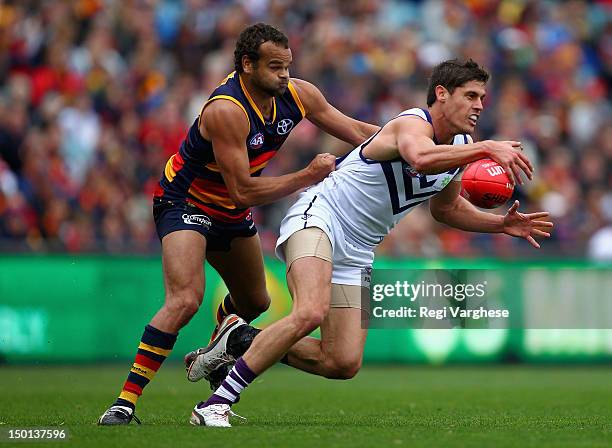 Garrick Ibbotson of the Dockers under pressure from Graham Johncock of the Crows during the round 20 AFL match between the Adelaide Crows and the...