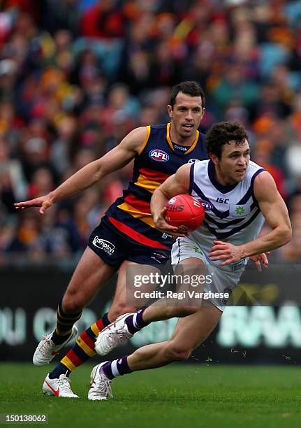 Hayden Ballantyne of the Dockers under pressure from Michael Doughty of the Crows during the round 20 AFL match between the Adelaide Crows and the...