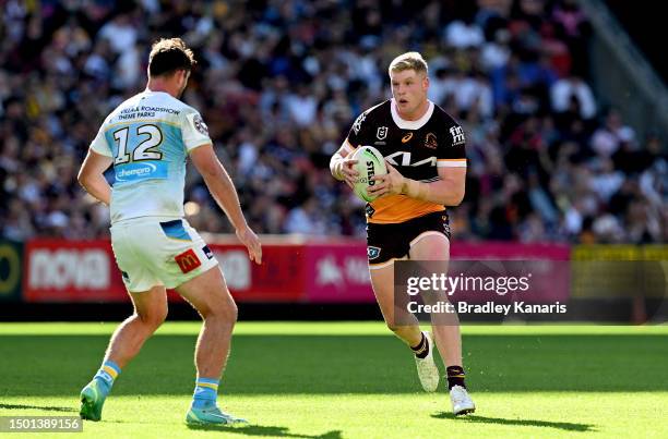 Tom Flegler of the Broncos looks to take on the defence of Joe Stimson of the Titans during the round 17 NRL match between Brisbane Broncos and Gold...