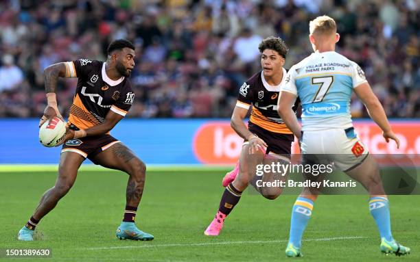 Ezra Mam of the Broncos passes the ball to Reece Walsh of the Broncos during the round 17 NRL match between Brisbane Broncos and Gold Coast Titans at...