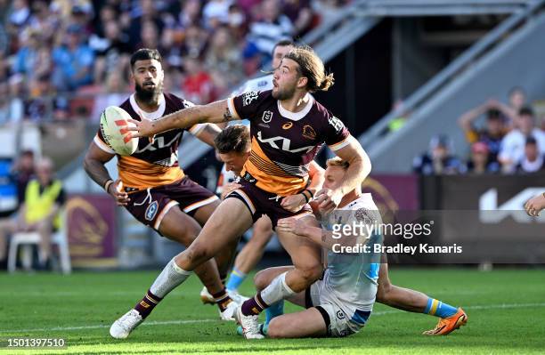 Patrick Carrigan of the Broncos offloads during the round 17 NRL match between Brisbane Broncos and Gold Coast Titans at Suncorp Stadium on June 25,...