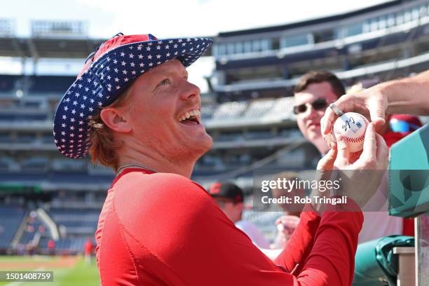 Andrew Abbott of the Cincinnati Reds signs autographs prior to the game between the Cincinnati Reds and the Washington Nationals at Nationals Park on...