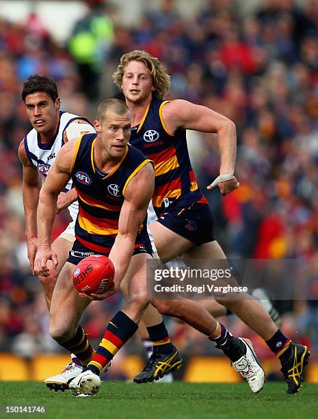 Scott Thompson of the Crows hand passes during the round 20 AFL match between the Adelaide Crows and the Fremantle Dockers at AAMI Stadium on August...