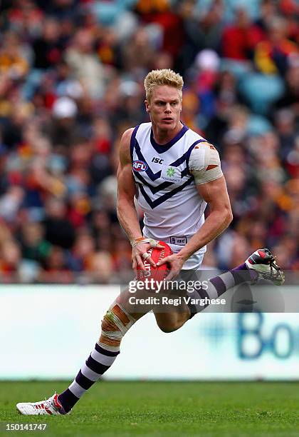 Adam McPhee of the Dockers runs with the ball during the round 20 AFL match between the Adelaide Crows and the Fremantle Dockers at AAMI Stadium on...