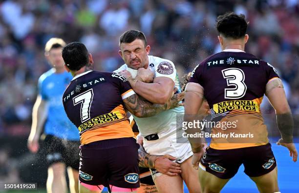 Chris Randall of the Titans takes on the defence during the round 17 NRL match between Brisbane Broncos and Gold Coast Titans at Suncorp Stadium on...
