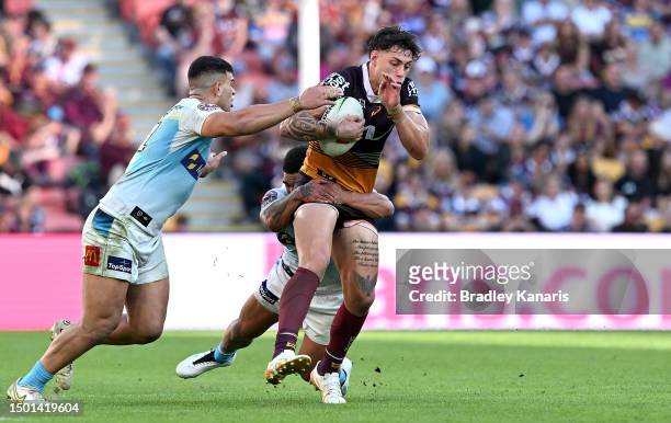 Jordan Riki of the Broncos takes on the defence during the round 17 NRL match between Brisbane Broncos and Gold Coast Titans at Suncorp Stadium on...