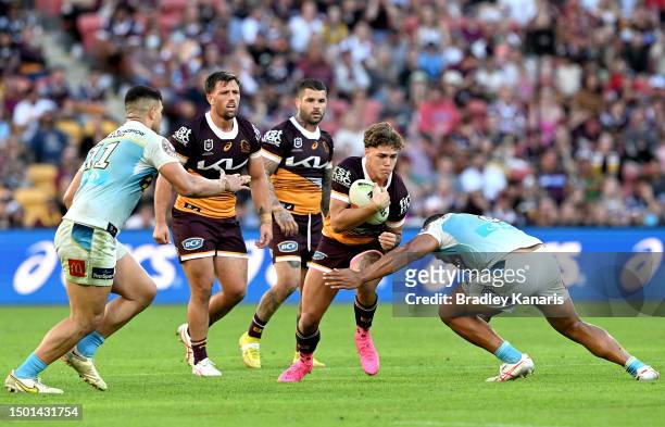Reece Walsh of the Broncos takes on the defence during the round 17 NRL match between Brisbane Broncos and Gold Coast Titans at Suncorp Stadium on...
