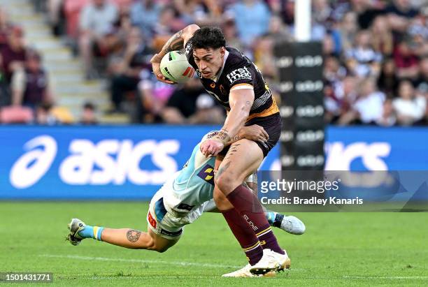 Jordan Riki of the Broncos is tackled during the round 17 NRL match between Brisbane Broncos and Gold Coast Titans at Suncorp Stadium on June 25,...