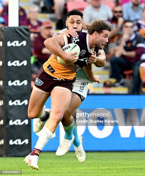 Patrick Carrigan of the Broncos attempts to break away from the defence during the round 17 NRL match between Brisbane Broncos and Gold Coast Titans...