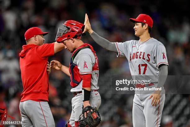 Shohei Ohtani and Mike Trout of the Los Angeles Angels celebrate after a 25-1 win in a game against the Colorado Rockies at Coors Field on June 24,...