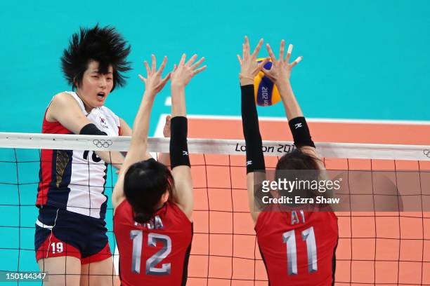 Risa Shinnabe and Ai Otomo of Japan defend the spike of Hee-Jin Kim of Korea during the Women's Volleyball bronze medal match on Day 15 of the London...