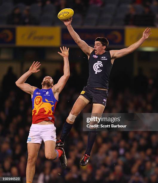 Matthew Kreuzer of the Blues and Ben Hudson of the Lions compete for the ball during the round 20 AFL match between the Carlton Blues and the...