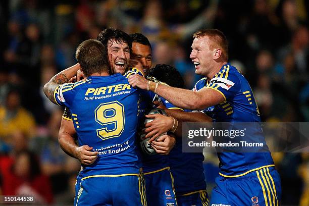 Nathan Hindmarsh of the Eels celebrates with team mates after scoring a try against the Roosters during the round 23 NRL match between the Parramatta...