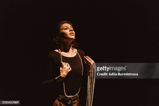 charming young woman singing in musical play on stage of university drama club - actress stage stock pictures, royalty-free photos & images