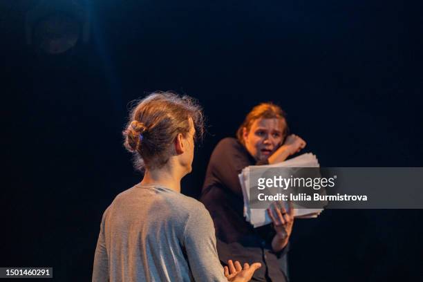talented young male participants of amateur theater rehearsing on stage in student theater club - scriptwriter stock pictures, royalty-free photos & images
