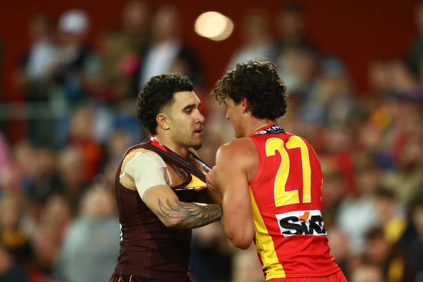 Tyler Brockman of the Hawks and Wil Powell of the Suns grapple during the Round 15 AFL match between Gold Coast Suns and Hawthorn Hawks at Heritage...
