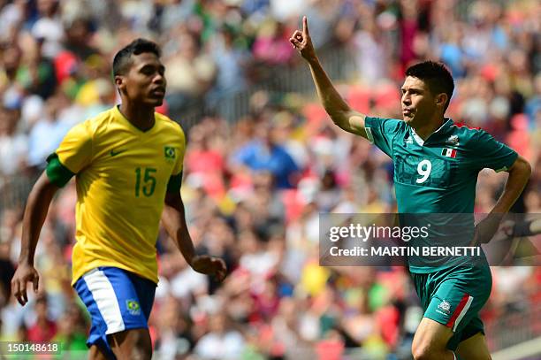 Mexico's forward Oribe Peralta celebrates after scoring the opening goal against Brazil in the men's football final match between Brazil and Mexico...