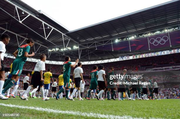 The teams enter the pitch ahead of the Men's Football Final between Brazil and Mexico on Day 15 of the London 2012 Olympic Games at Wembley Stadium...