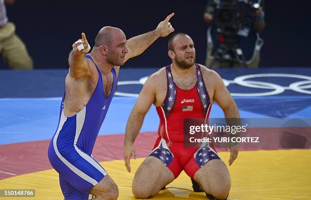 Tervel Ivaylov Dlagnev reacts after being defeated by Uzbekistan's Artur Taymazov in their Men's 120kg Freestyle semifinal match on August 11, 2012...